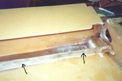 Optional Fuel Tank: Step 4. Tape the front and bottom of the forward panel with polyethylene tape to prevent Q-cell from adhearing to it. Attach the 2 layer strip to the lower forward edge of the panel with small easily removable pieces of tape. (stir stick were inserted between the panel and strip to allow space for mill fiber during final bonding of the forward panel) The object is to precisely place the strip but allow removal of the panel (small pieces of tape) without damaging the position of the strip after curing. Place a bead of thick Q-cell in the fuel tank where the lower forward fuel tank panel will go. Position the forward panel in place making sure the Q-cell will cure and hold the 1 strip in place. After it cures, carefully remove the forward panel making sure not to dislodge the strip attached to the wing. Radius and laminate the strip in place. This will serve as a flange to seal and support the forward fuel panel on the bottom.