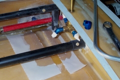 Started making the fuel line that goes from the main tank pickup to the fuel selector valve. I think the foam in the bottom of my wing is a little thicker than it should be because it was imposible to get the fuel line under the aileron pushrod and above the inner wing surface with any kind of acceptable clearance between them. So I cut a channel in the inner wing skin for extra clearance and glassed it in. The photo shows the edges of the laminate with peel-ply on them... Use peel-ply everywhere, it makes for much nicer laminates.