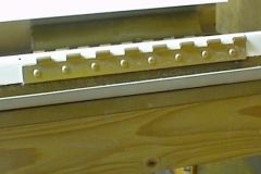 Hinge alodined and riveted to aileron shear web.