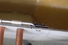 In this view, you can see the counter-sunk screw holding the aluminum strip and nu-plate against the pin. The aluminum strip is just flexible enough to allow the pin to slide under when installing.