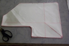 Finished cutting 12 fiberglass cloths that are laminated between the wheelwell side panel and fuselage.