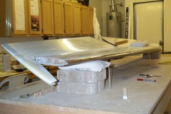 Sanded the inboard ends of the elevators, redrilled the inboard elevator ribs, bolted the elevators to the horizontal stabilizer and sanded, sanded, sanded, sanded, sanded&#8230-&#8230-&#8230-&#8230-. It took a lot of sanding to allow the elevator 22 deg. of travel on the down side.