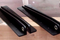 Fabricated main wing attach brackets and primered them with zinc chromate and painted them black.