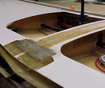 Laminated center seam and added the unidirectional cloth above the aft spar. Filled a few voids between the main spar and the upper skin by drilling holes in the upper skin and injecting resin in the voids.