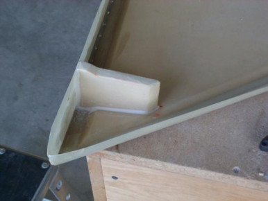 Cut and fit the foam for the rudder actuator rib. Sealed the rib and bonded it in place. Cut the cloth and laminated 4 layers on each side. This photo was taken after I had bonded the rib in place.