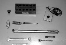 Spark plug tray, adjusting tool, gap gage, spark plug socket and extension, magneto timer, torque wrench, combination wrenches, ratchet, socket and extension
