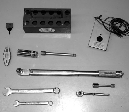 Spark plug tray, adjusting tool, gap gage, spark plug socket and extension, magneto timer, torque wrench, combination wrenches, ratchet, socket and extension