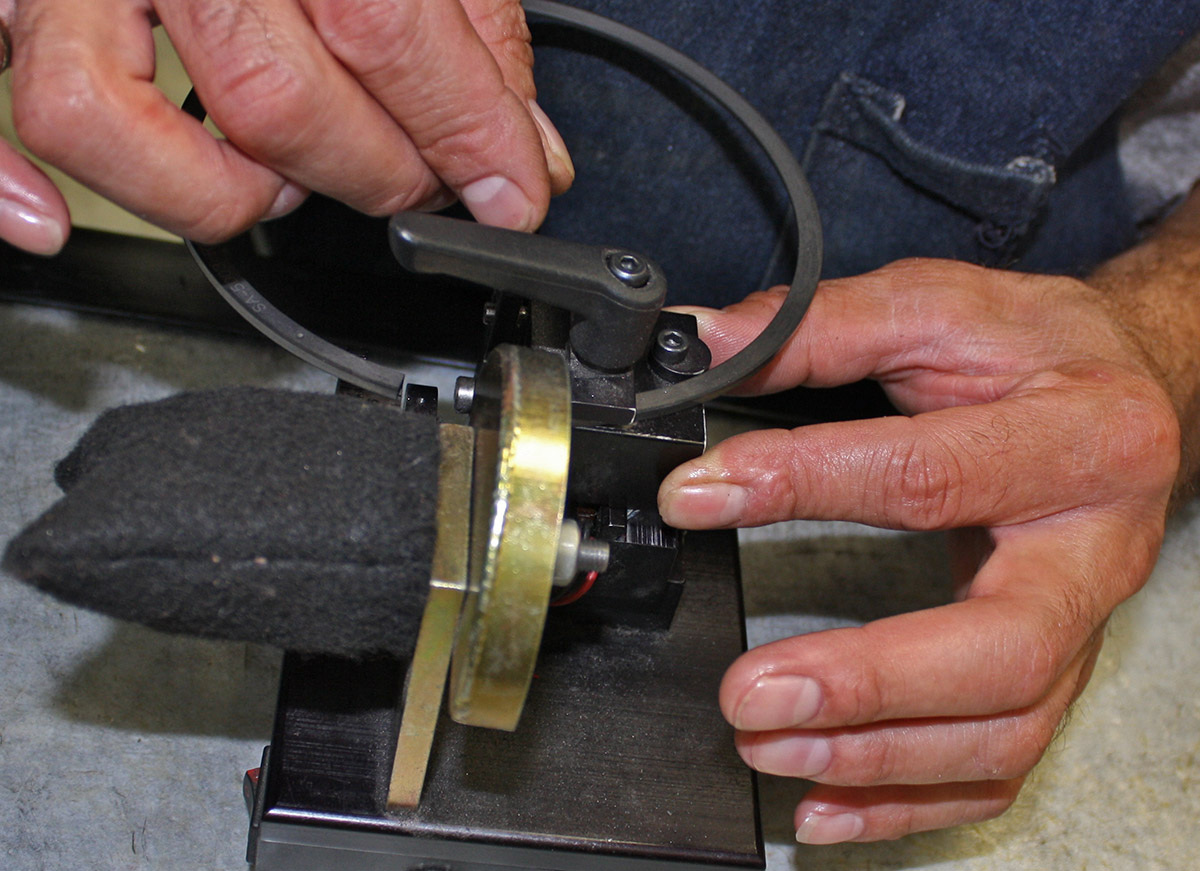 Gapping the piston rings on a ring filer.