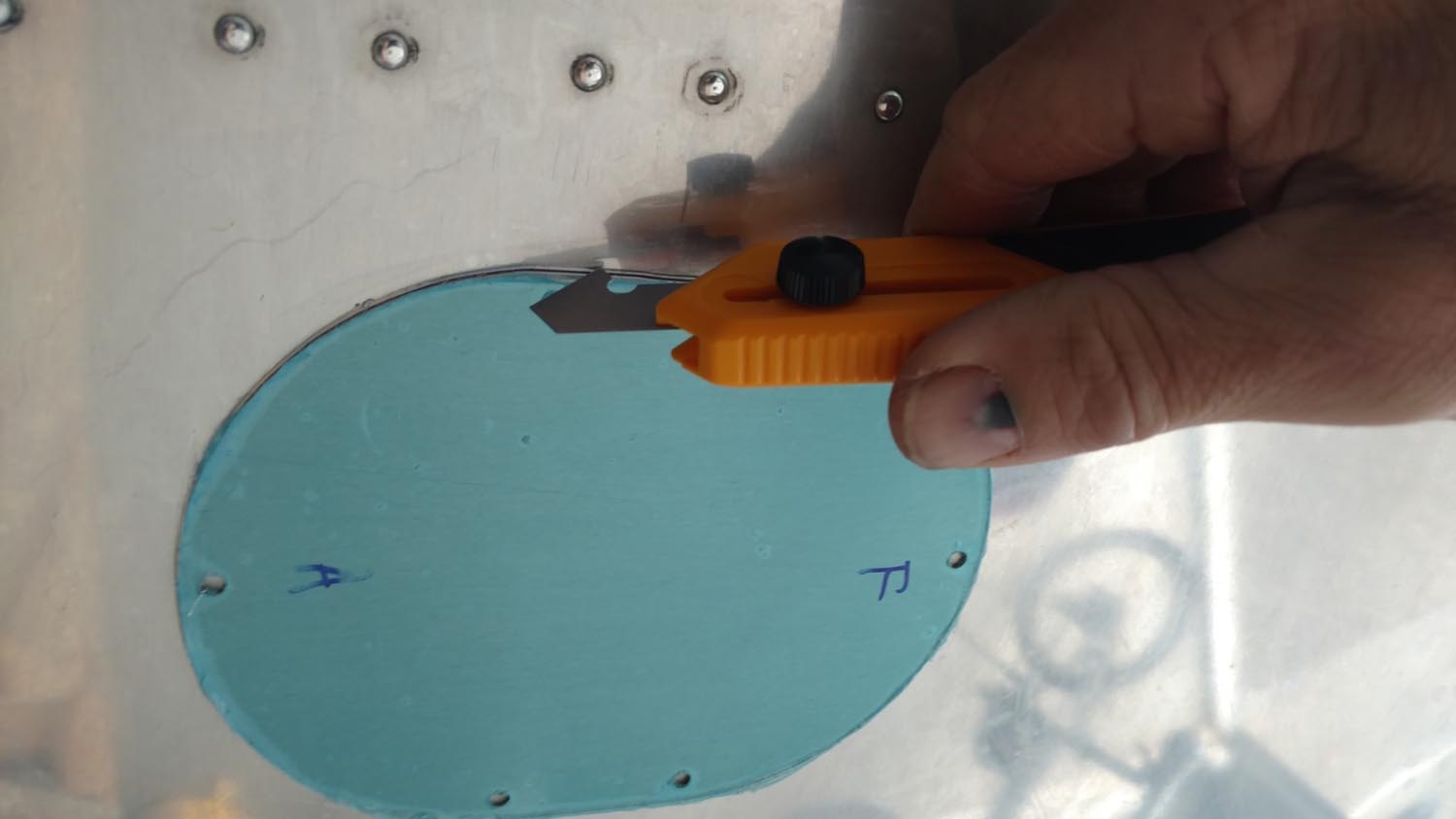 Using an “Olfa Knife” to create an access hole in the wing.